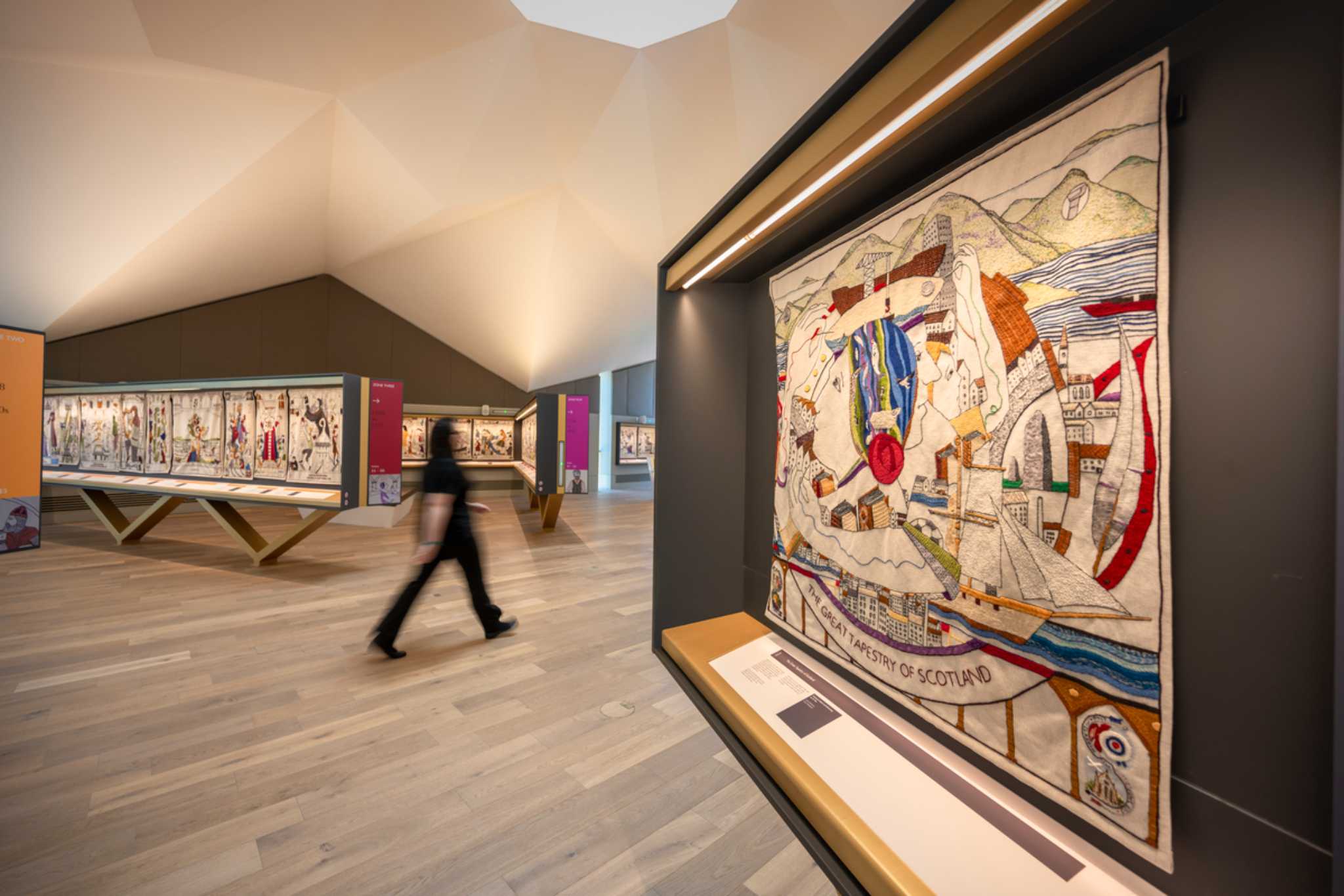 A woman walks through an exhibition space