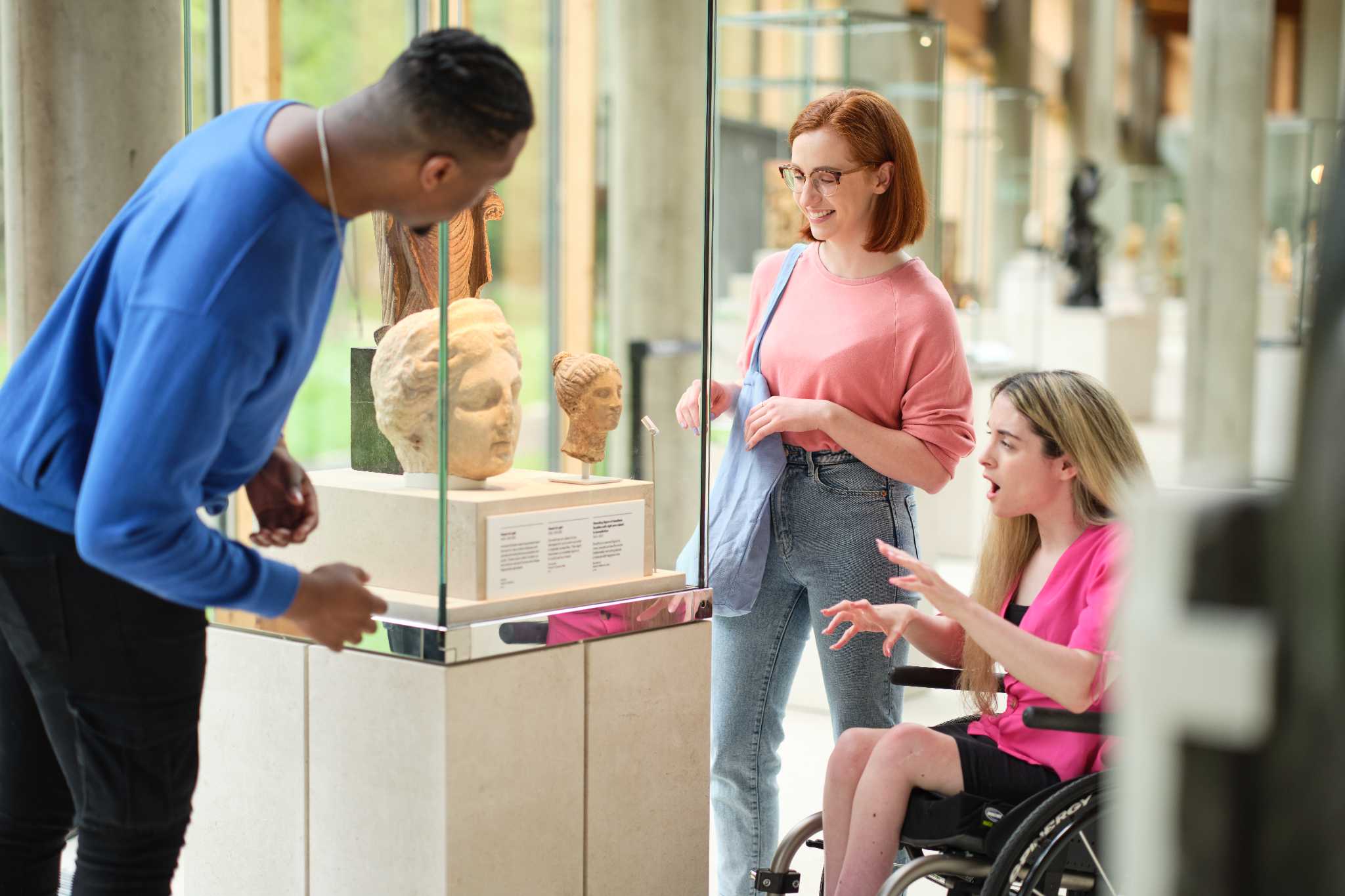 Three friends are enjoying looking at an exhibit