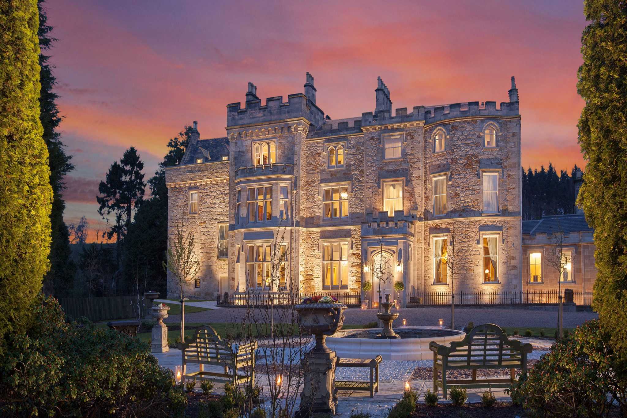 A castle is lit up at night.