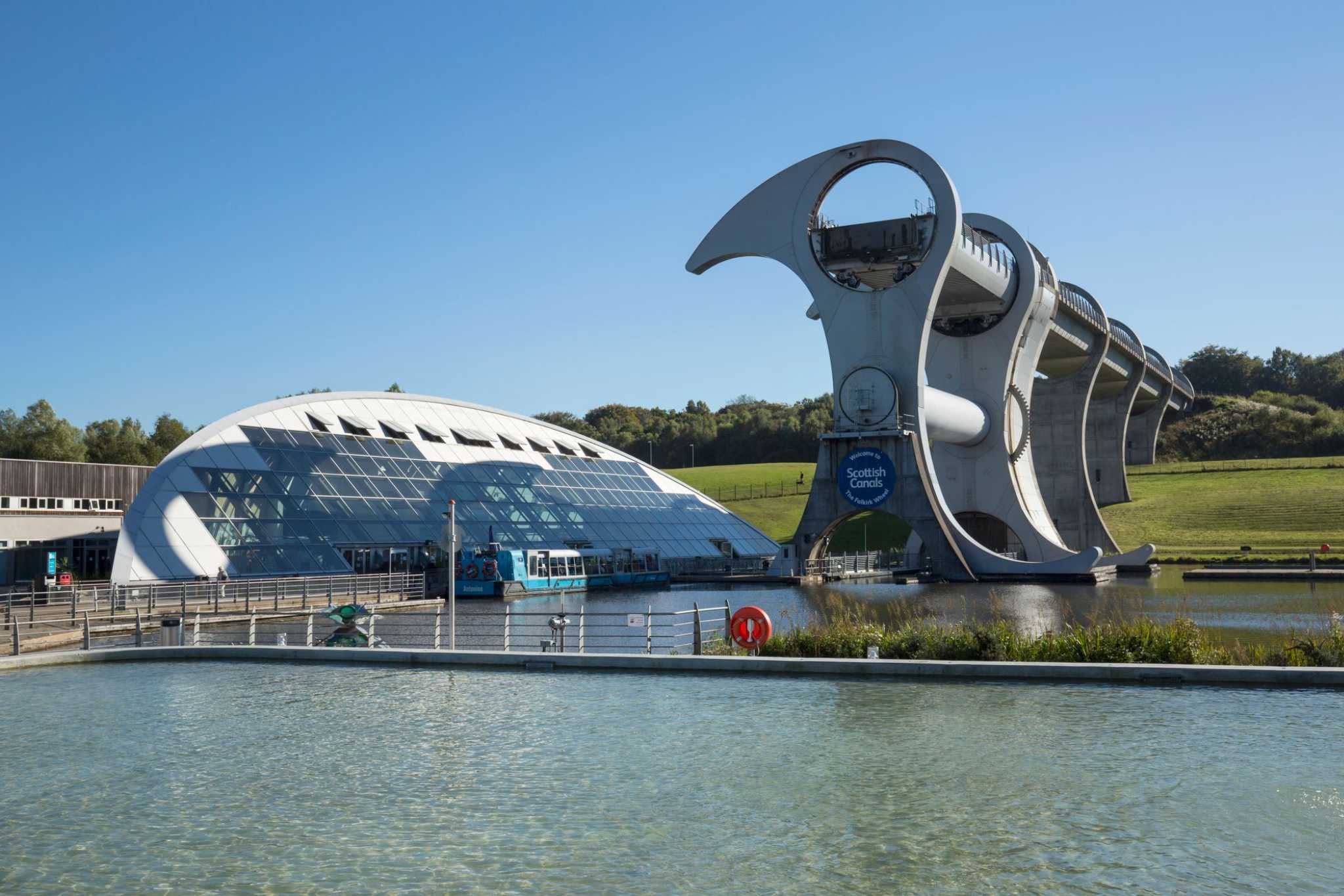 Looking across a canal towards the structure of the Falkirk Wheel