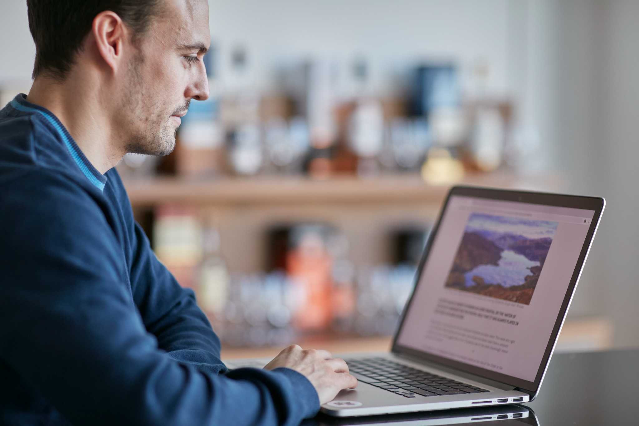 A man works on a laptop